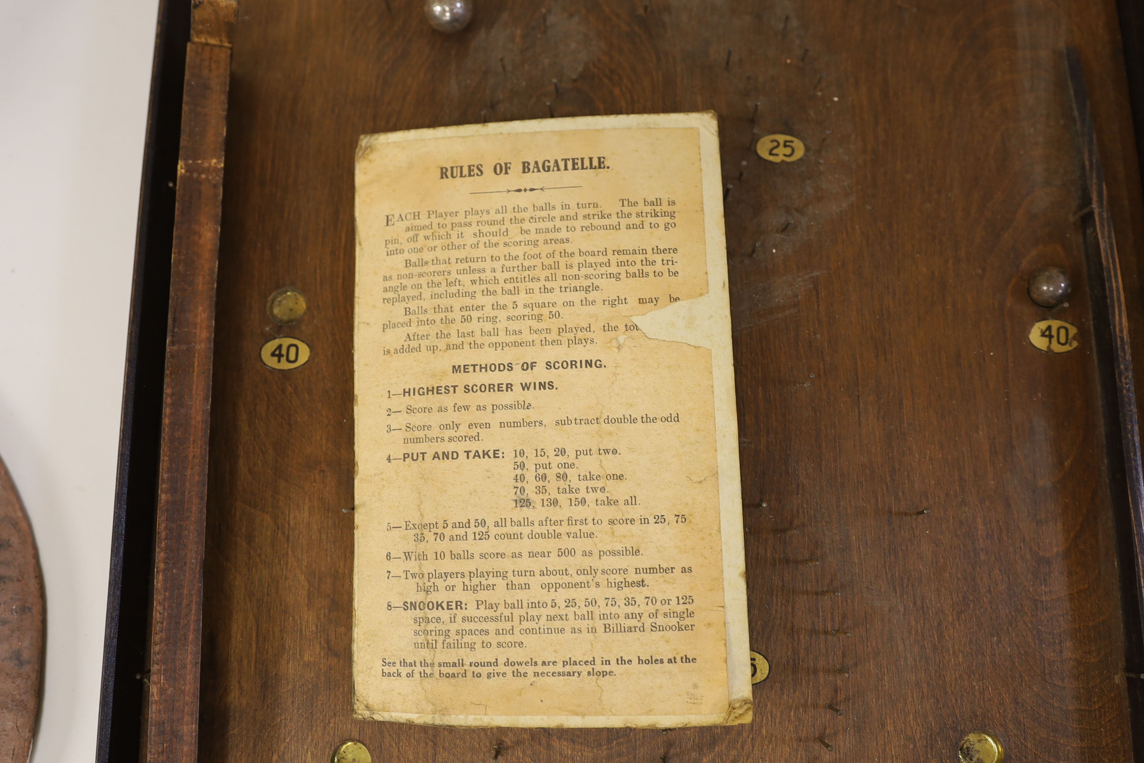 A bagatelle board with balls and instructions